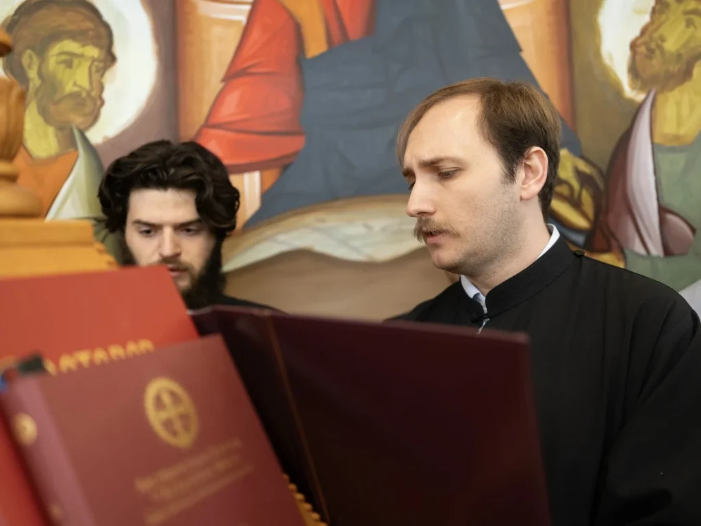 Men singing religious hymns in a church.