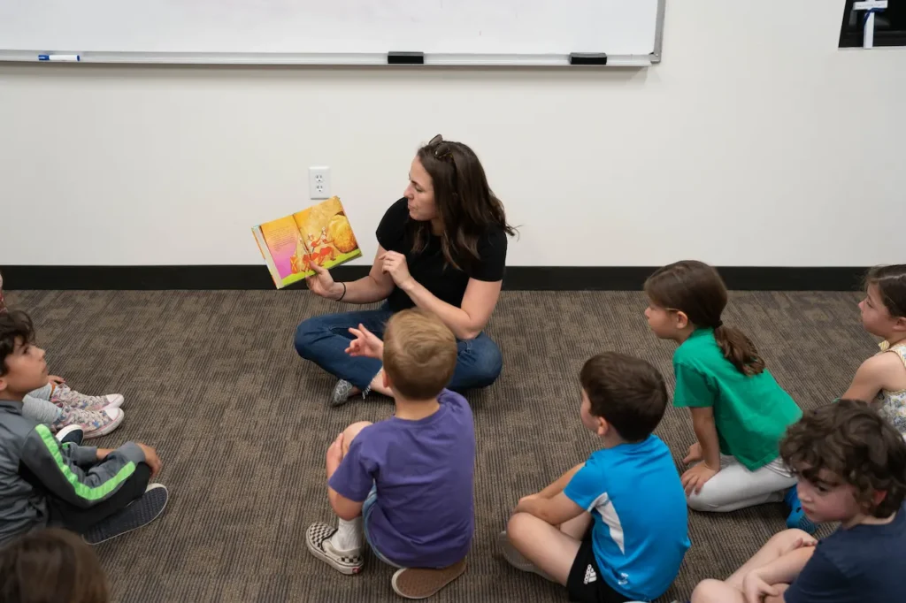 Teacher reading story to attentive children.